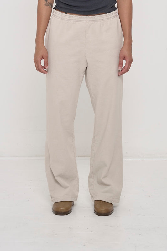 Bottom half of a person wearing Trash Fleece Apartment Pants in Oat