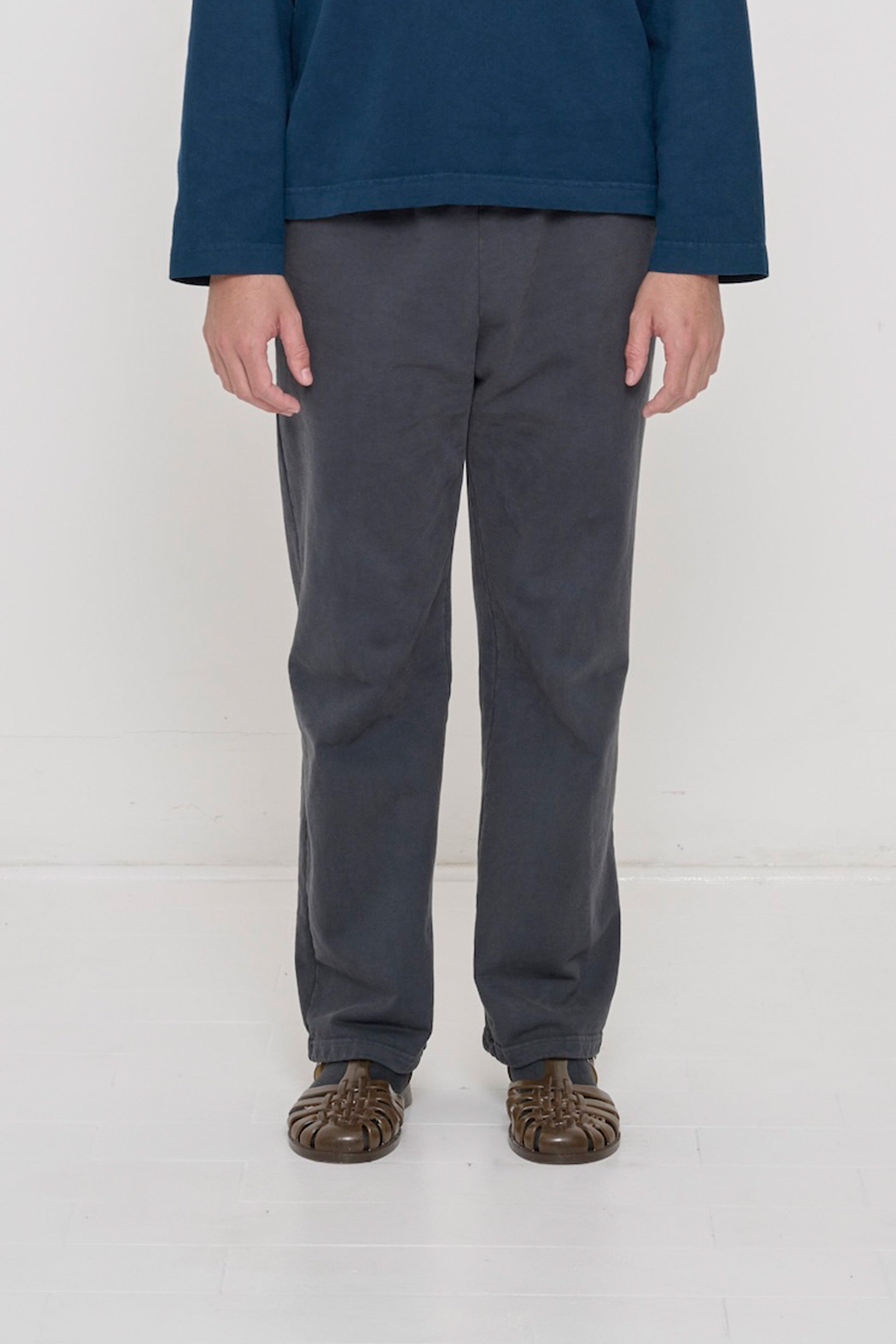 Close-up front view of a person wearing Trash Fleece Apartment Pants in Slate, showing waistband and relaxed drape.