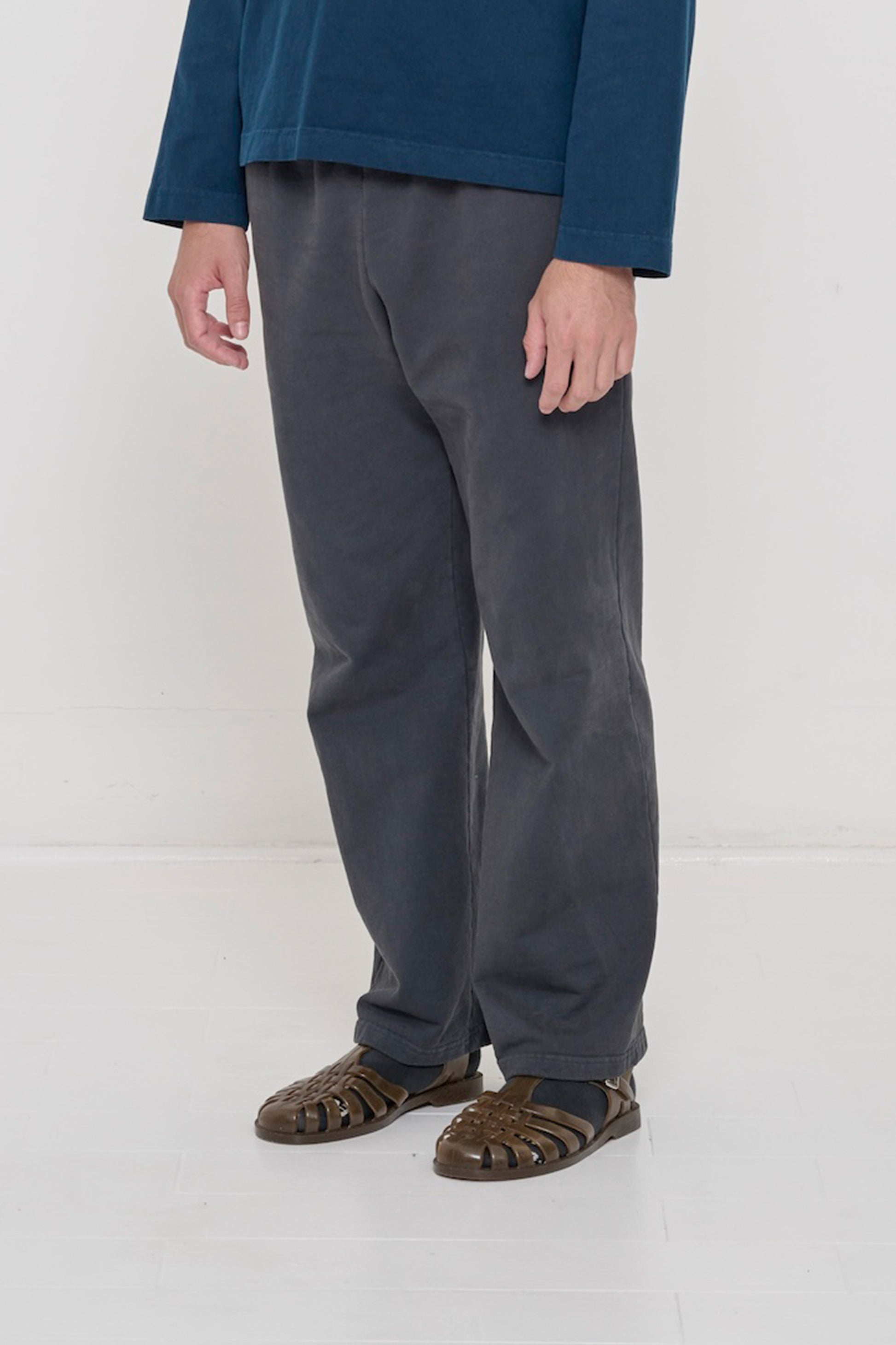 Person facing 45-degrees to the front in Slate Apartment Pants, showing inseam and outseam.