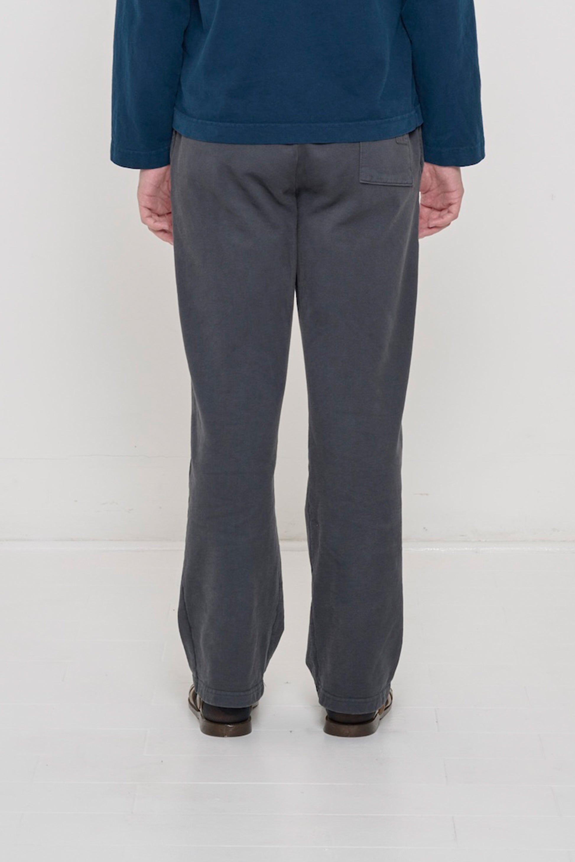 Close-up back view of a person wearing Trash Fleece Apartment Pants in Slate, highlighting the back pocket.