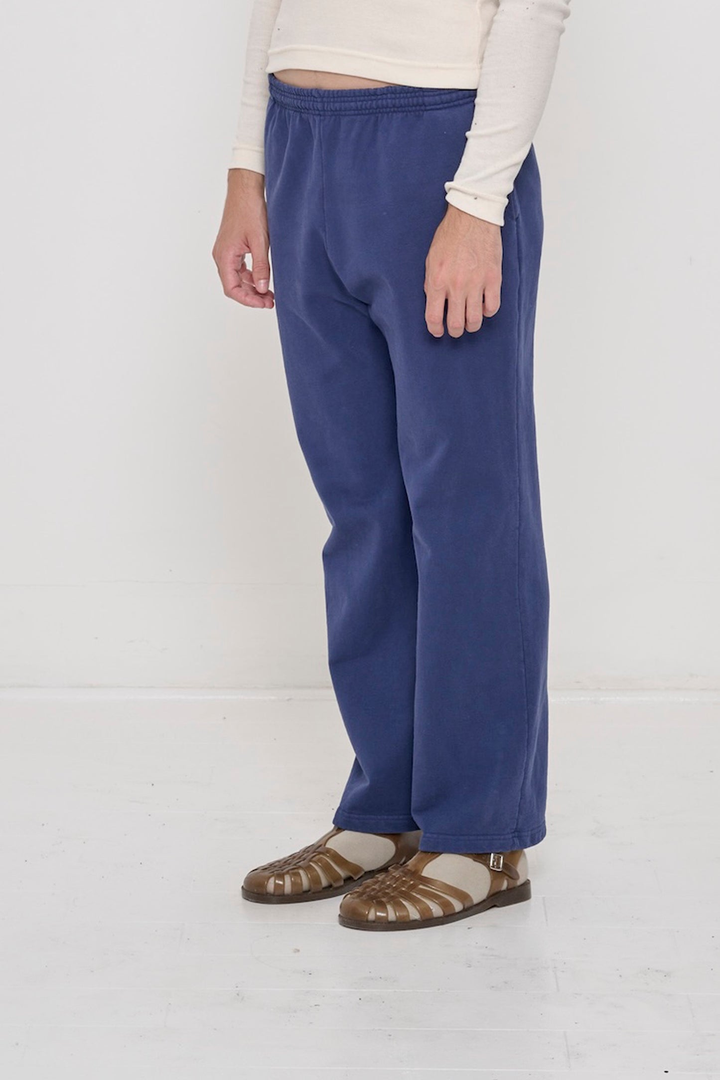 Person facing 45-degrees to the front in Washed Navy Apartment Pants, showing inseam and outseam.