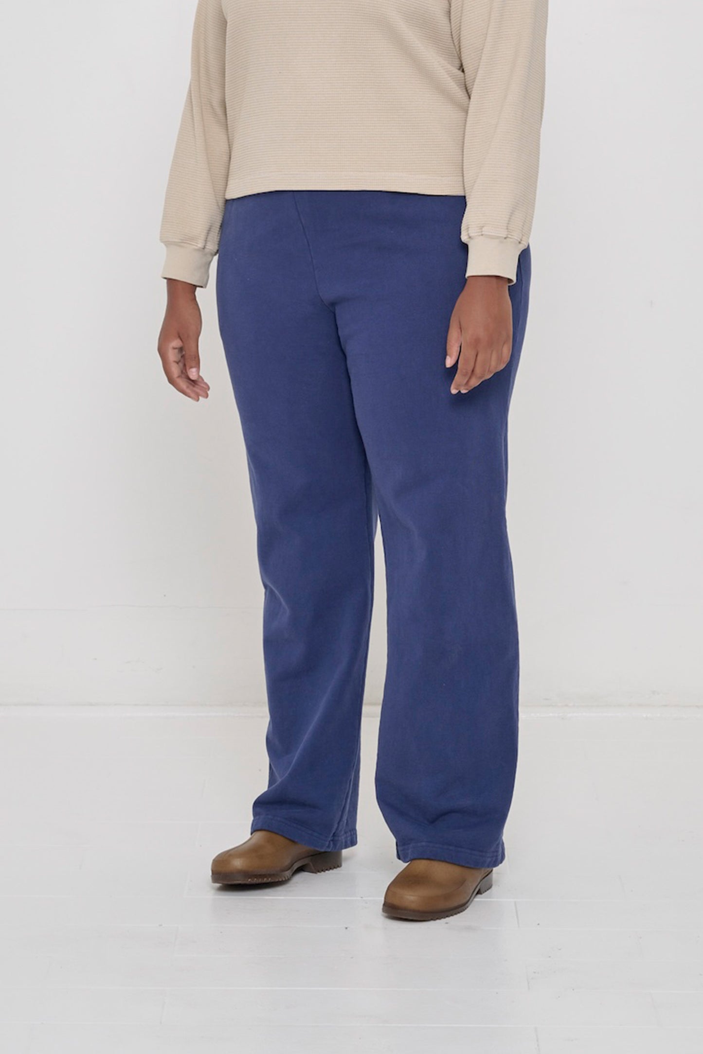 Person facing 45-degrees to the front in Washed Navy Apartment Pants, showing inseam and outseam.