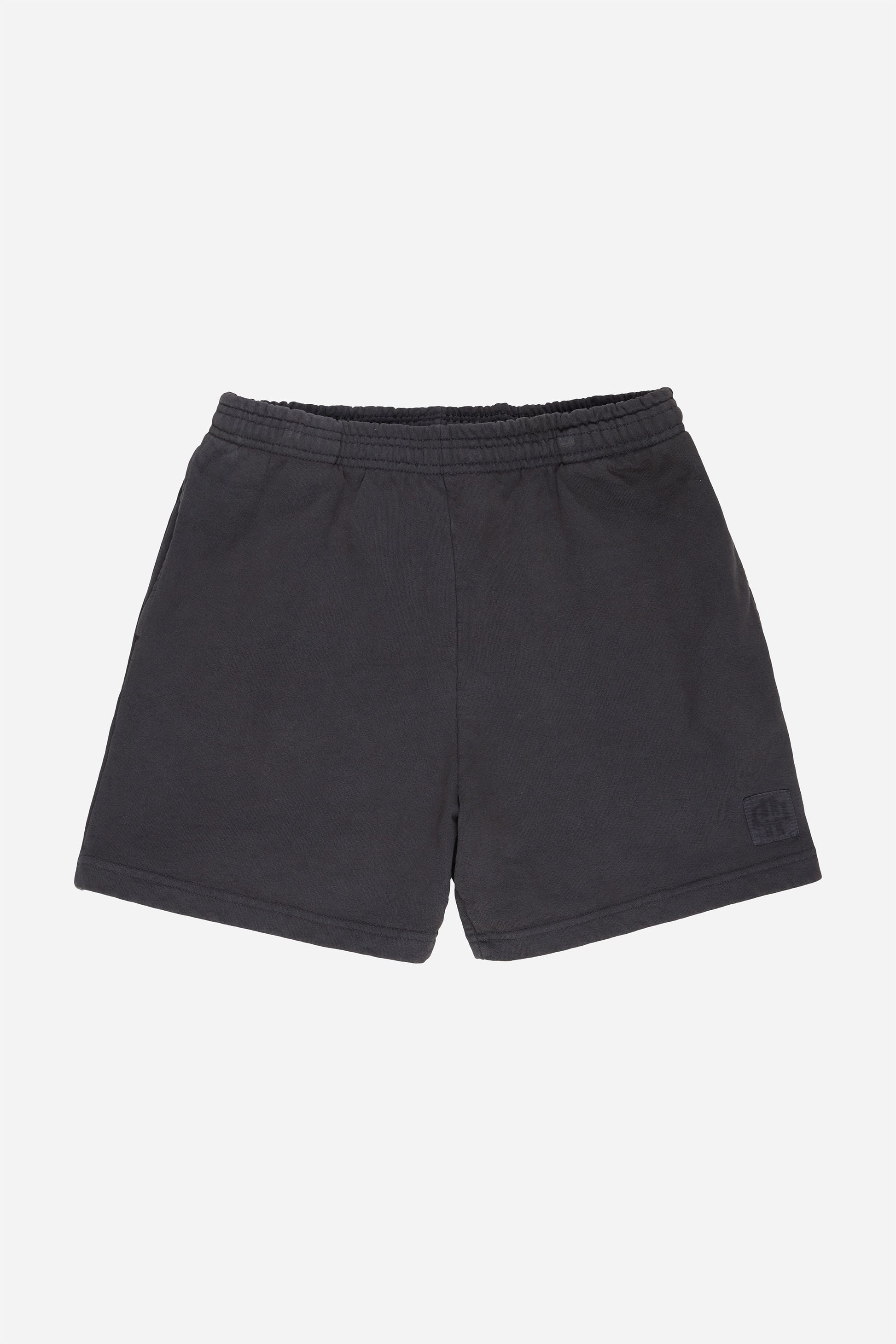 Flat lay of Slate Trash Fleece Everyday Shorts shows elastic waist and E.W patch logo on bottom left shorts leg.