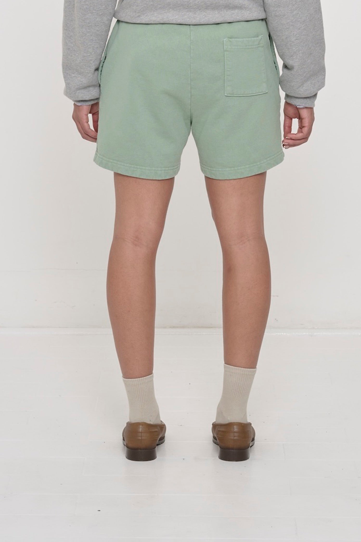 Back view: Wasabi Trash Fleece Everyday Shorts on a person, waist down, showing relaxed fit and back right pocket.
