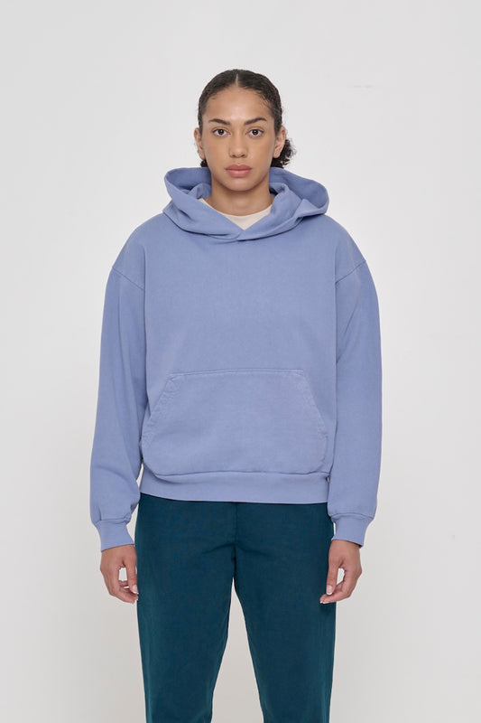 A 5'8" woman in a size S Periwinkle Trash Hoodie. Hem hits her hip.