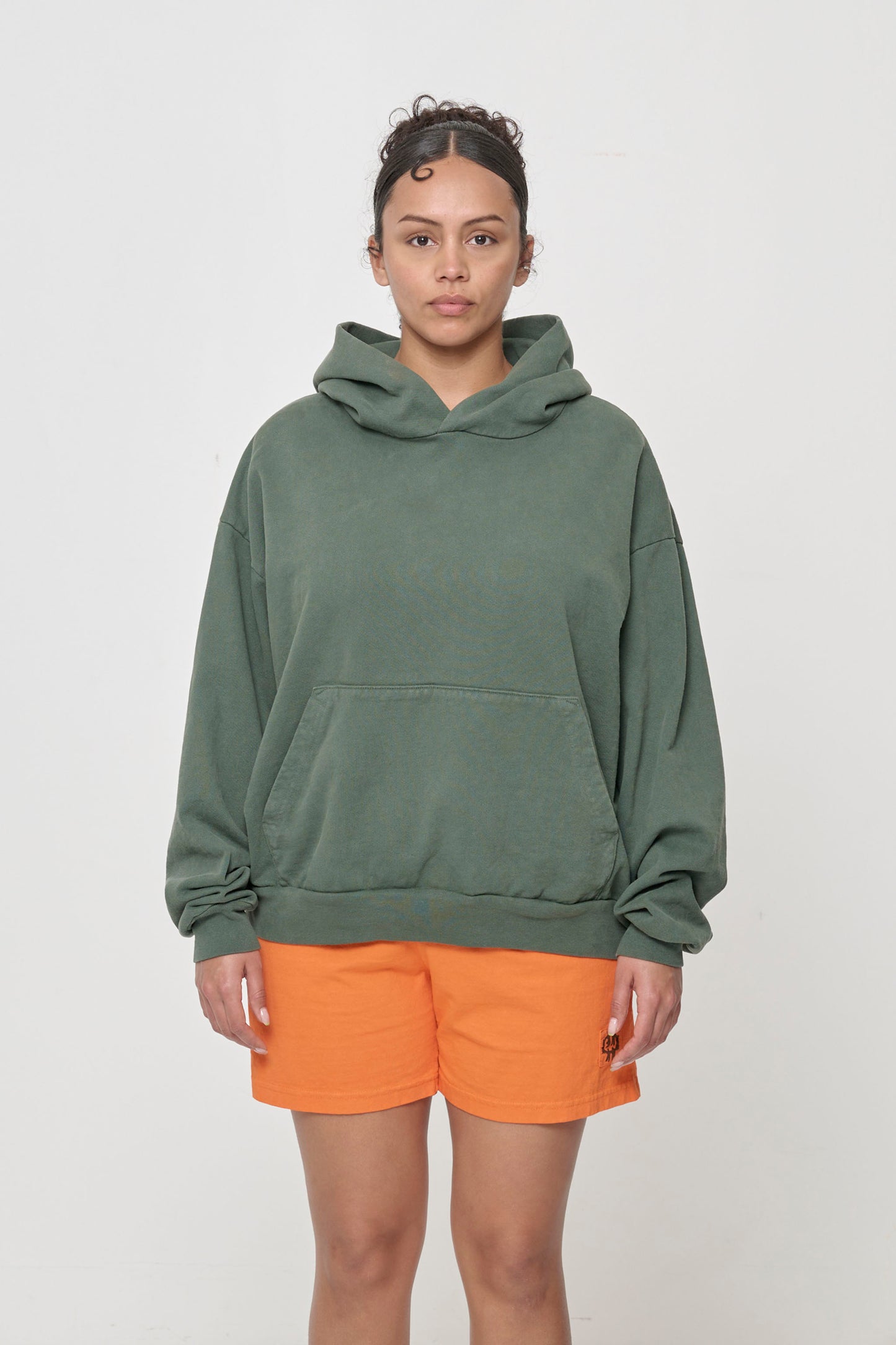 Front view: 5'7" woman wearing Pine Trash Hoodie in size M. Hem hits her lower hip.