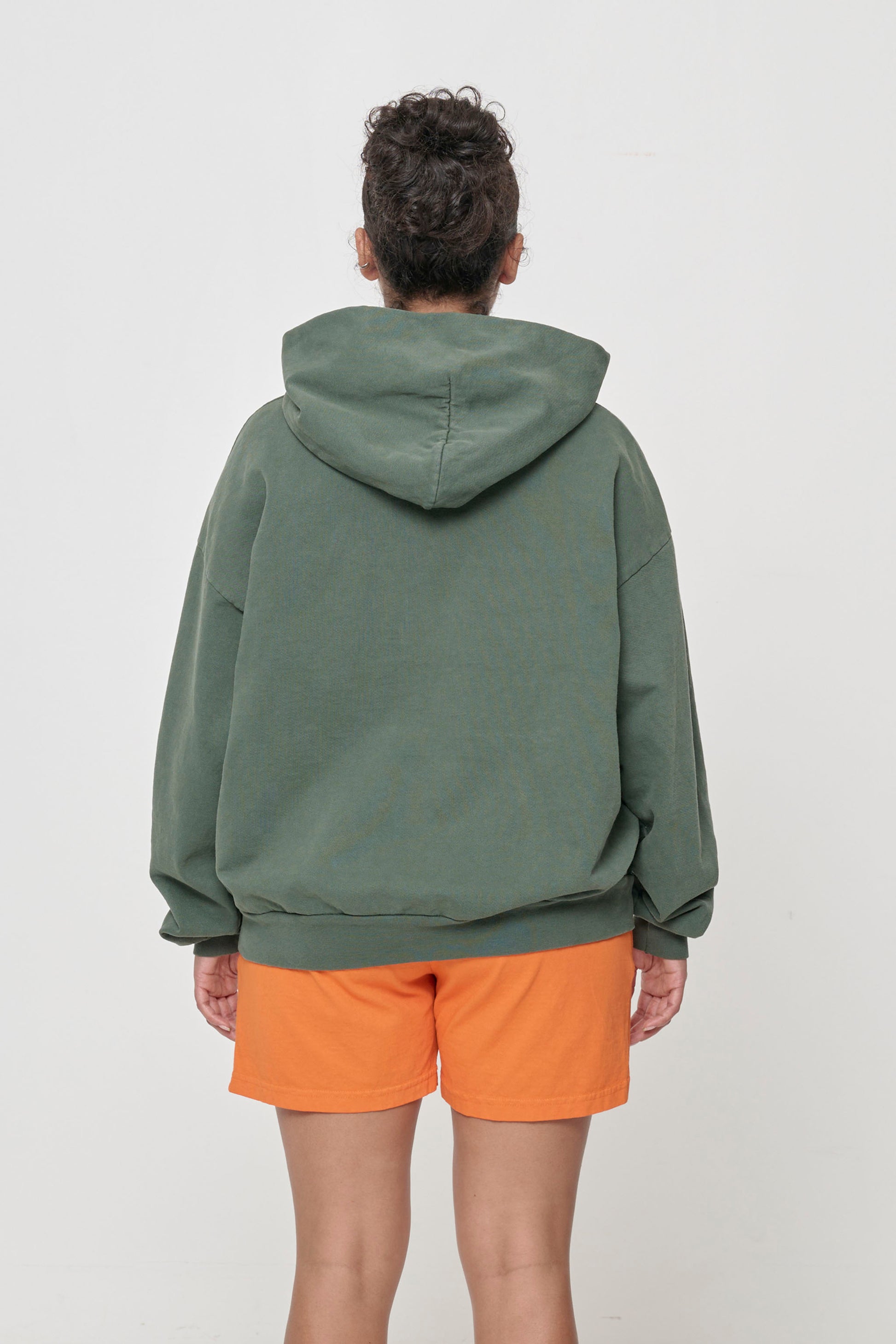 Back view: Woman wearing Pine Trash Hoodie, highlighting the hood.