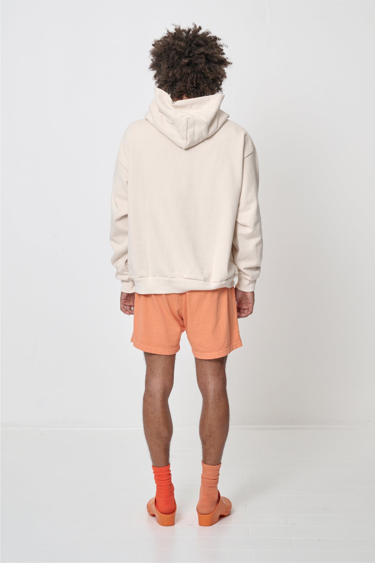 Back view: Man wearing Scour Trash Hoodie, highlighting the hood.