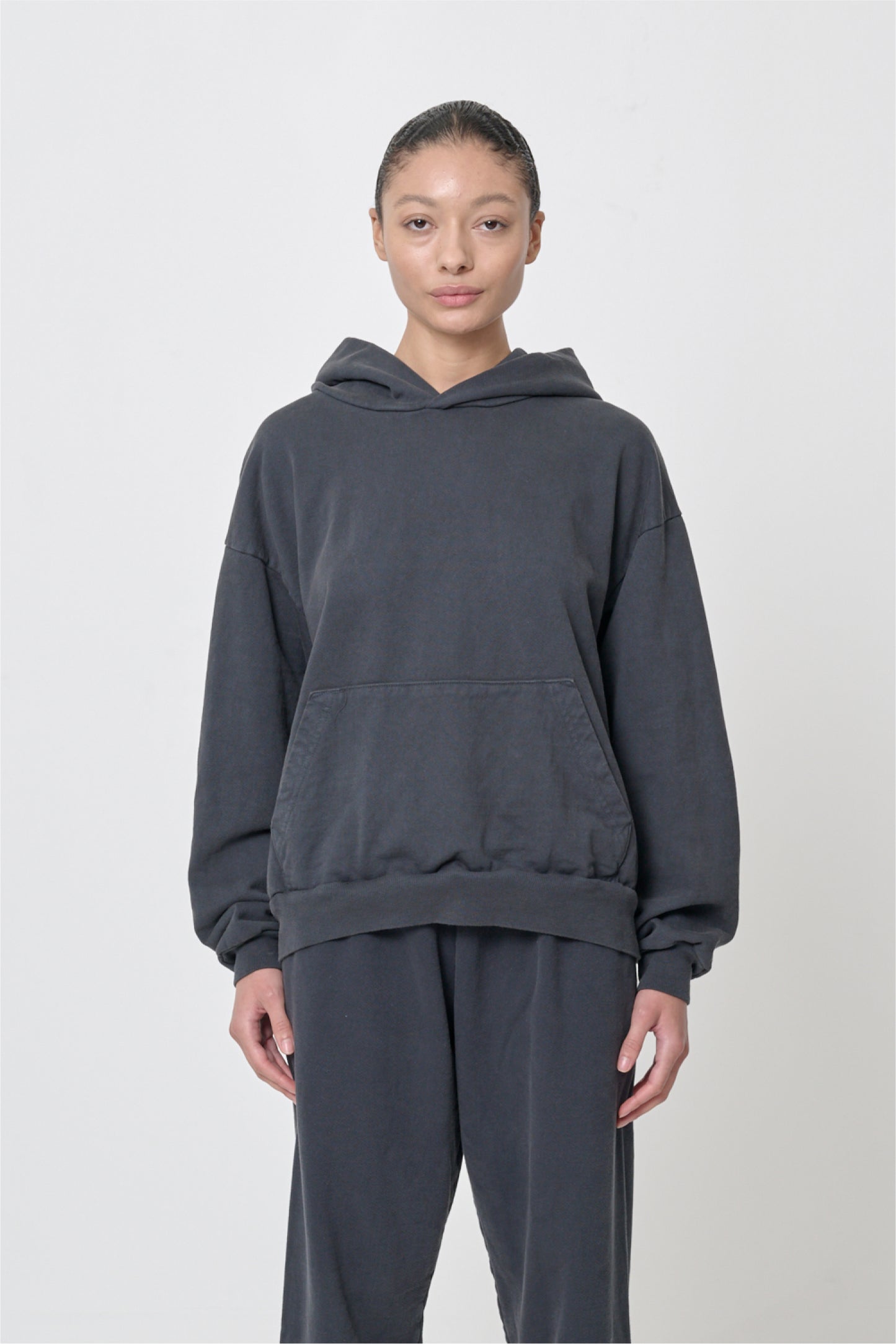 Front view: 5'8" woman wearing Slate Trash Hoodie in size S. Hem hits her lower hip.