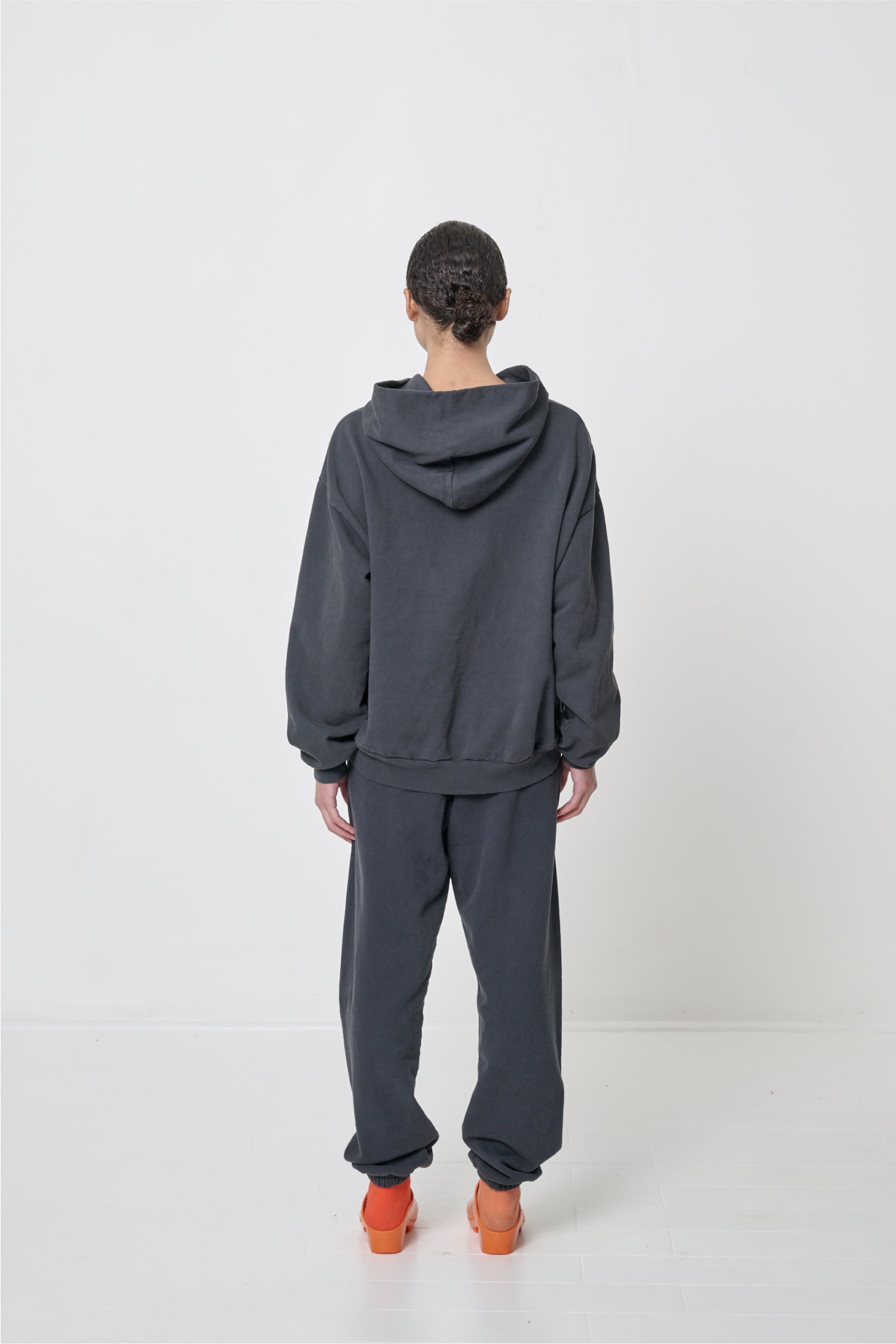 Back view: Woman wearing Slate Trash Hoodie, highlighting the hood.