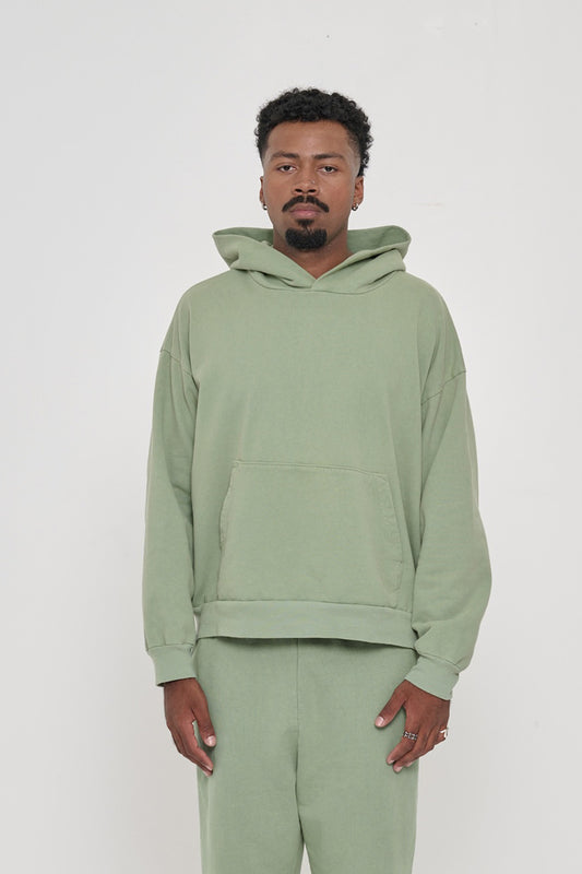 Front view of a man wearing a Wasabi Trash Hoodie. Hem hits his hip.