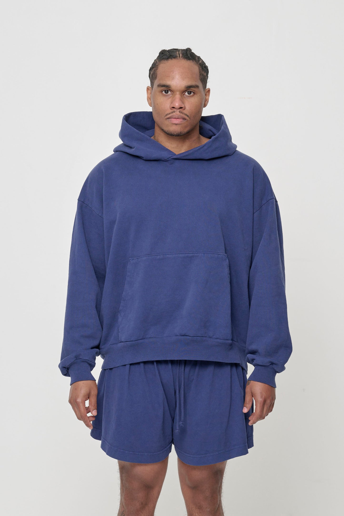 Front view: 6' man wearing Washed Navy Trash Hoodie in size L. Hem hits his lower hip.