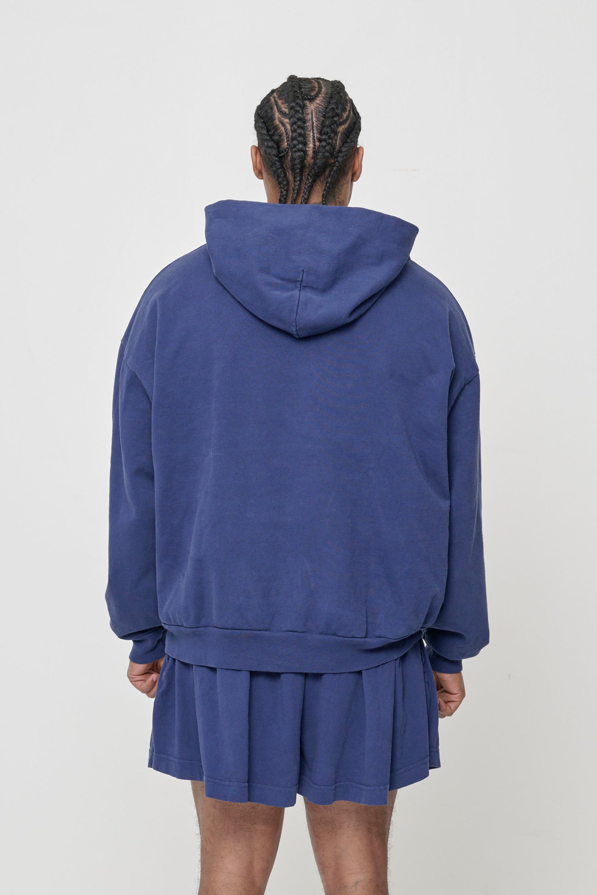 Back view: Man wearing Washed Navy Trash Hoodie, highlighting the hood.
