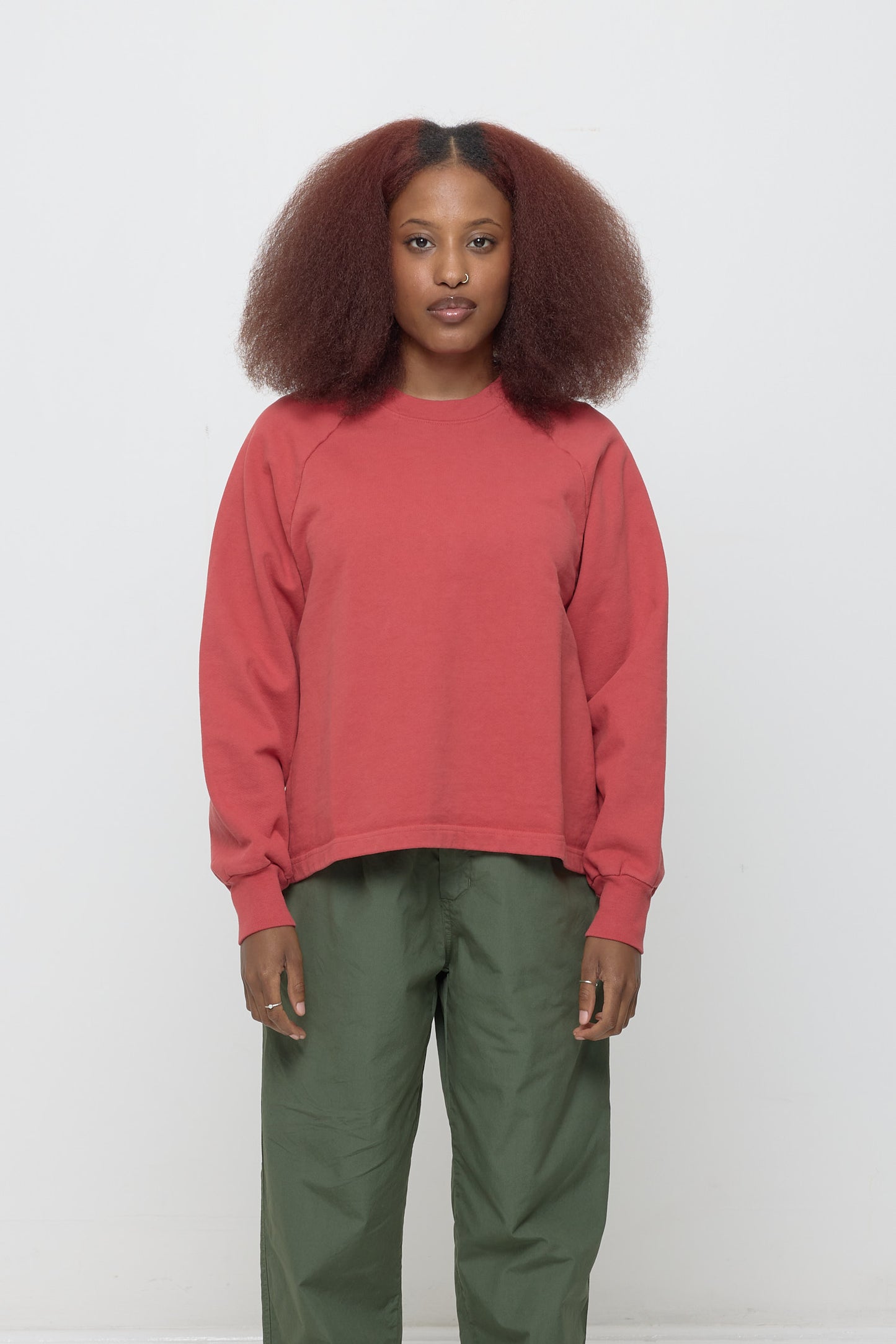 Front view: 5'3" woman wearing a Cedar Trash Raglan in size XS. Hem hits her lower mid hip.
