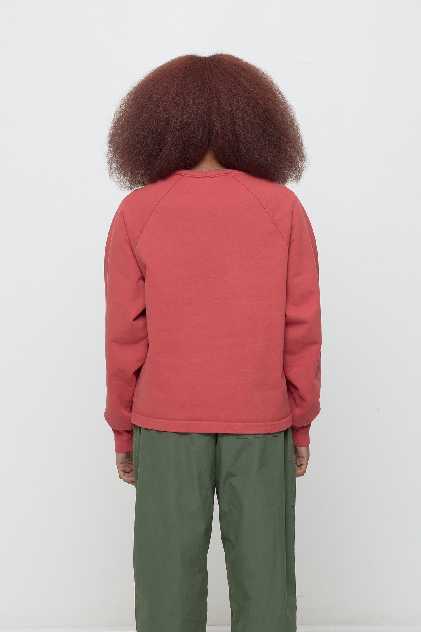 Cedar Trash Crewneck, back view on a person. Relaxed throughout except for the rib cuffs.