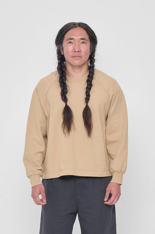 A 5'11" man wearing a Sand Storm Trash Raglan in size L. Hem hits his middle hip.