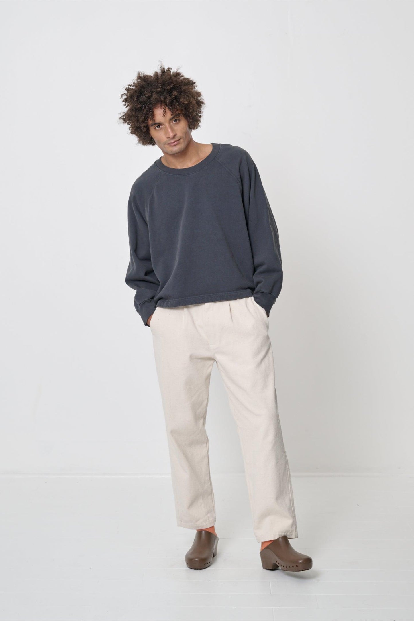 Front full length: man in a Slate Trash Raglan with hands in Life Uniform Pants pockets, showcasing boxy fit.