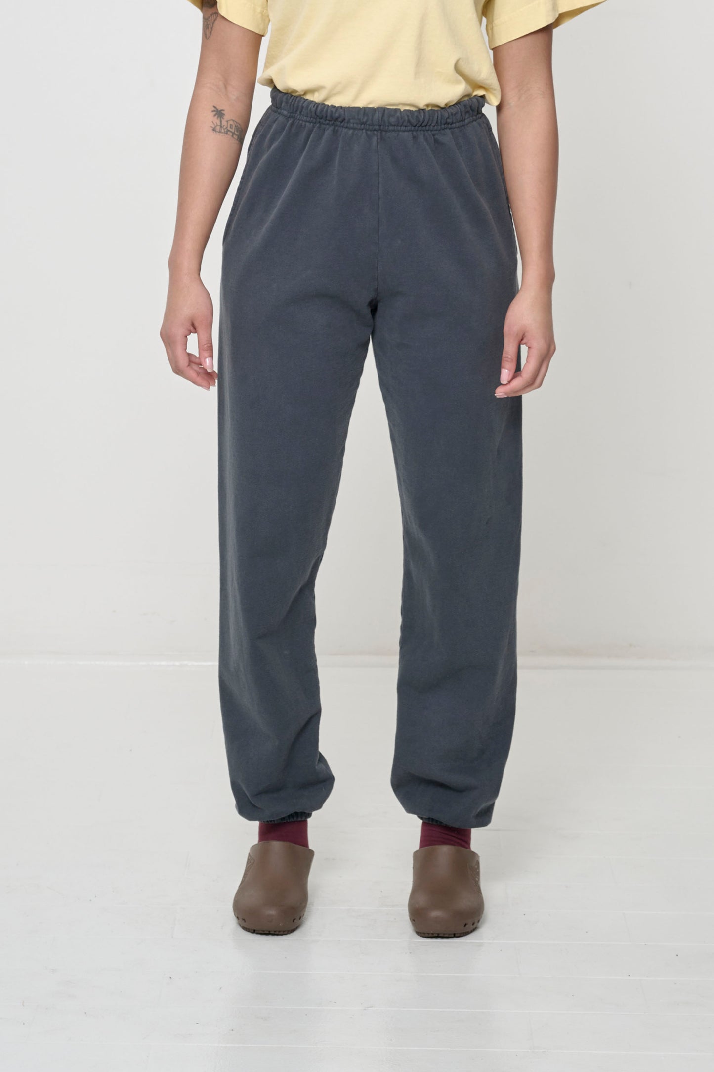 Front view: 5'8" person in size S Slate Trash Sweatpants, relaxed fit, slight bunching at the ankles.