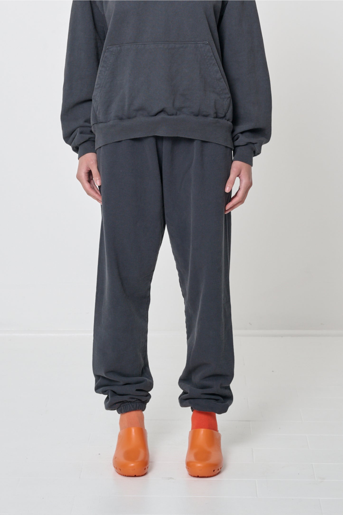 Front view: 5'8" person in size S Slate Trash Sweatpants, relaxed fit, slouchy bunching at the ankles.