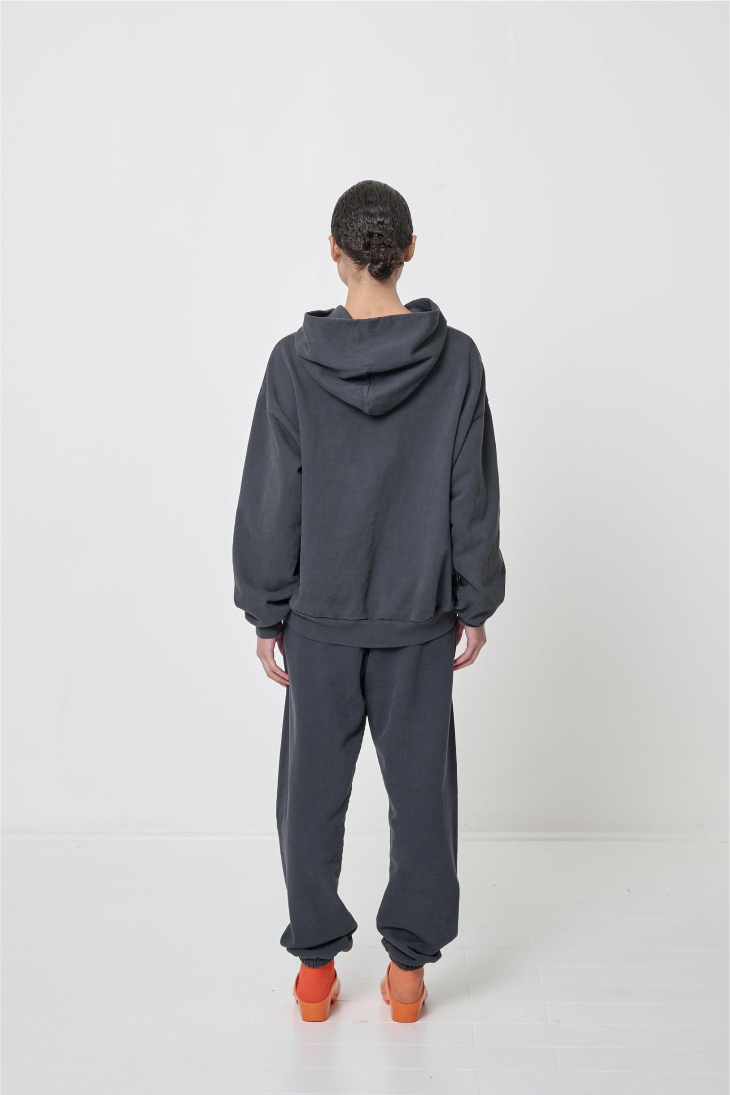 Back view: person wearing Slate Trash Sweatpants, relaxed fit throughout, sized up for slouchy bunching at ankles.