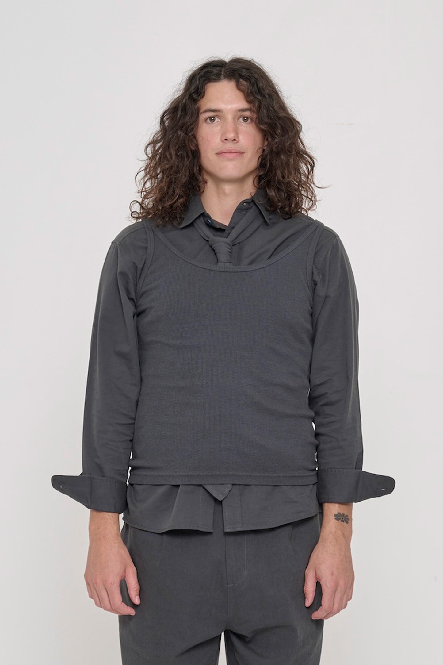 Person wearing Slate Trash Tie tucked into Slate Rib Tank over Slate Button-Up Shirt.