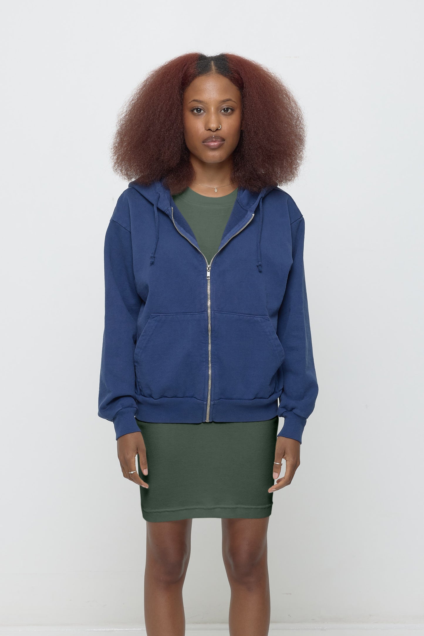 Front view: 5'3" woman wearing Washed Navy Trash Zip Up Hoodie in size XS. Hem hits her lower hip.