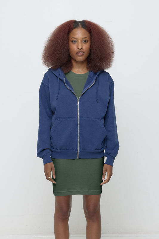 A 5'3" woman wearing Washed Navy Trash Zip Up Hoodie in size XS. Hem hits her lower hip.
