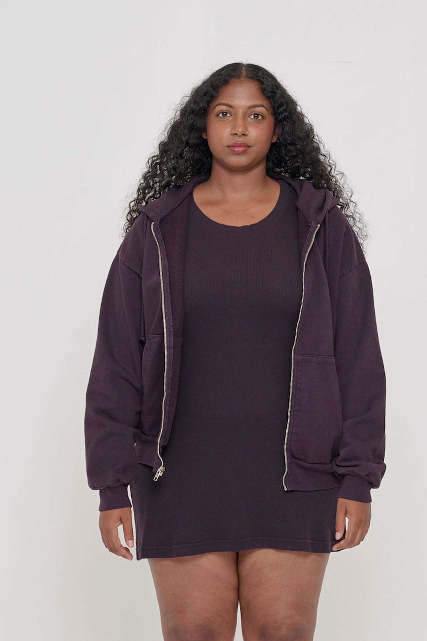 Front view of a person wearing Mulberry Trash Zip Up Hoodie. Hem hits mid hip.