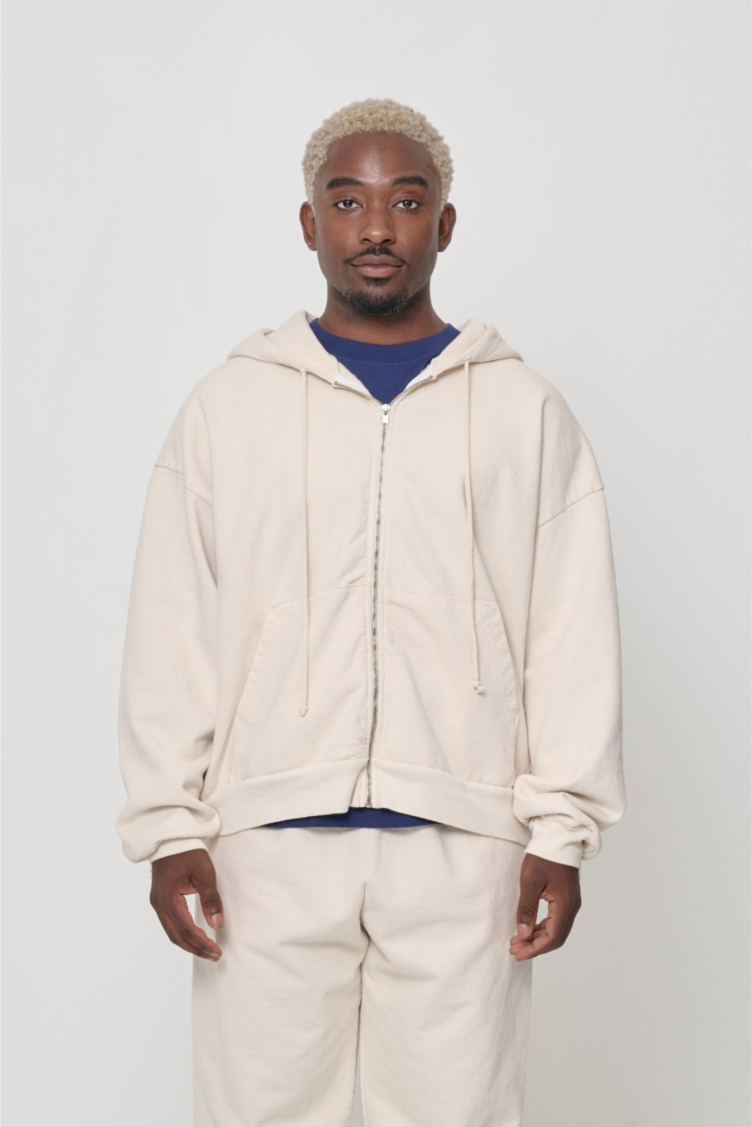 Front view: man wearing Scour Trash Zip Up Hoodie. Hem hits mid hip.