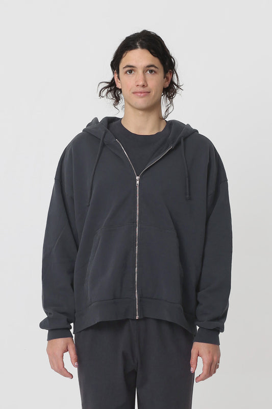 A 6' person in a size L Slate Trash Zip Up Hoodie. Hem hits their lower hip.
