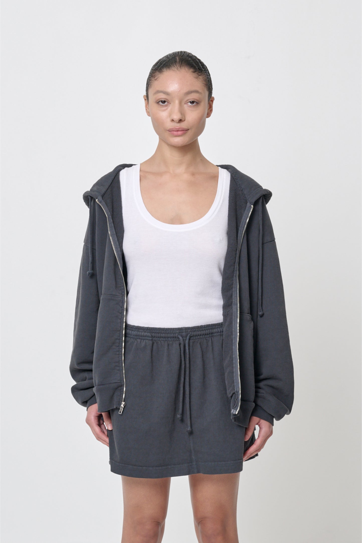 Front view: 5'8" woman wearing unzipped Slate Trash Zip Up Hoodie in size M. Hem hits her lower hip.