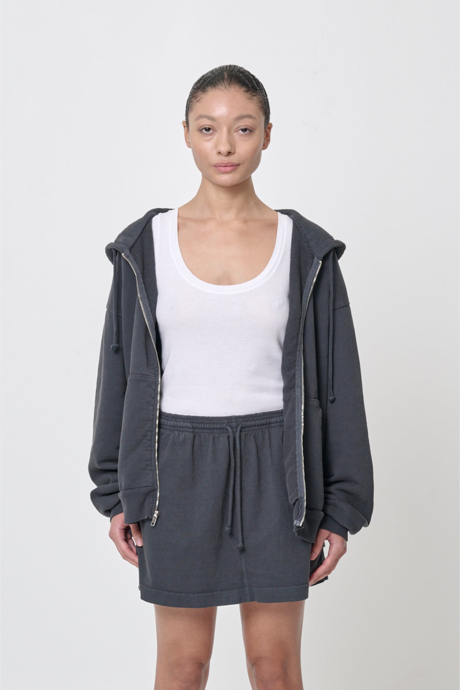 Front view: 5'8" woman wearing unzipped Slate Trash Zip Up Hoodie in size M. Hem hits her lower hip.