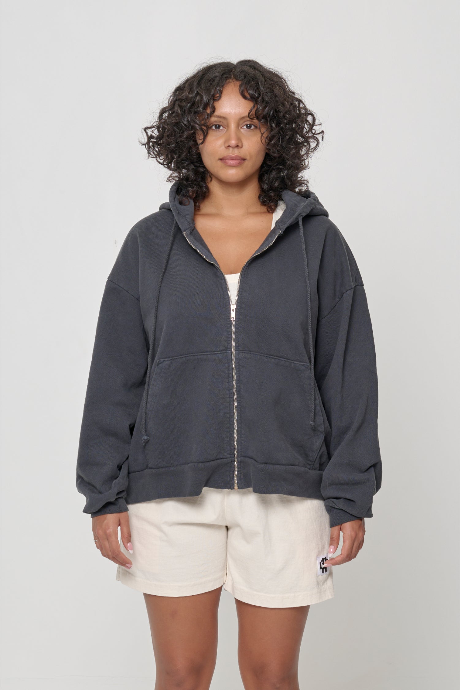 Front view: 5'7" woman wearing Slate Trash Zip Up Hoodie in size M. Hem hits lower mid hip.