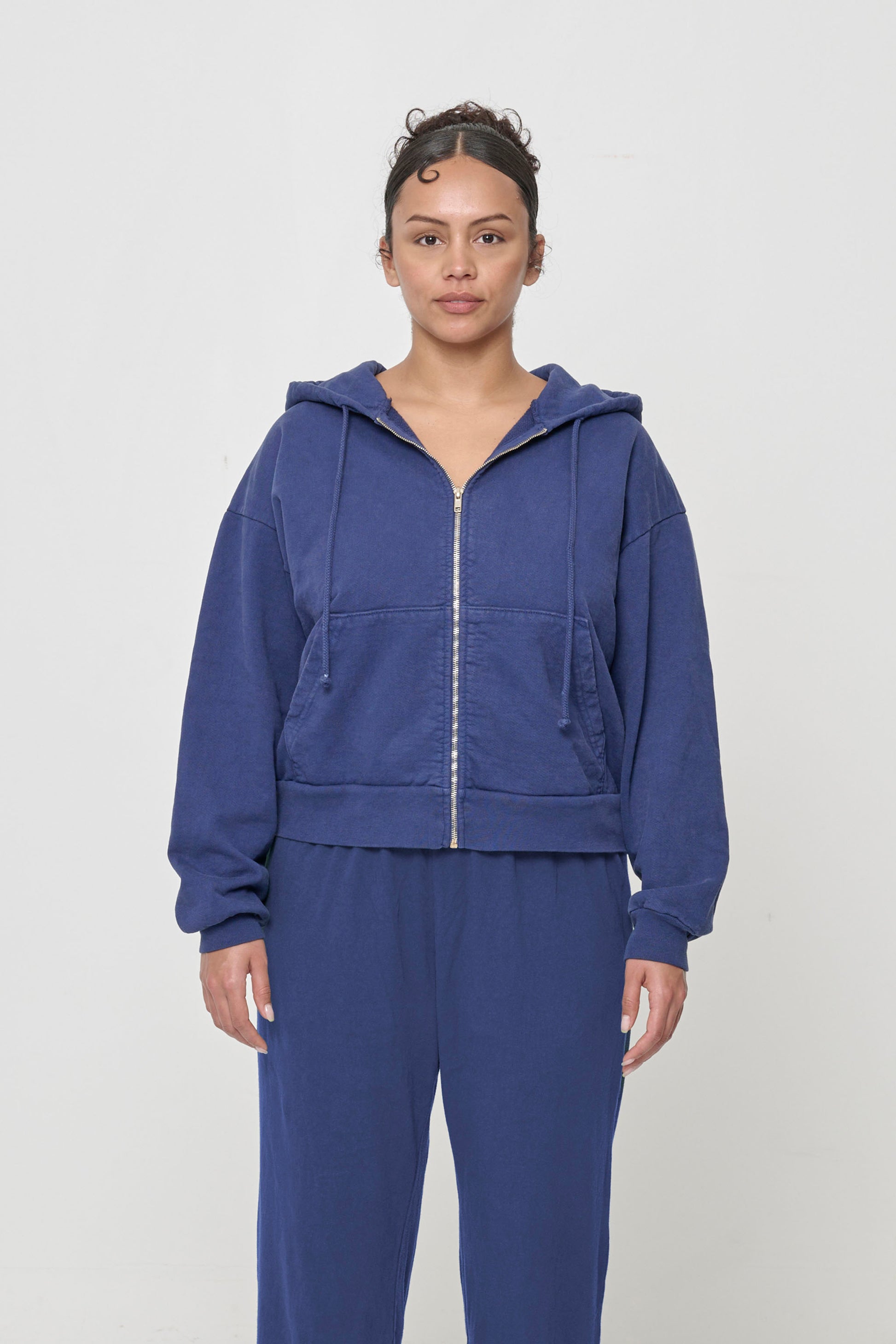 Front view: 5'7" woman wearing Washed Navy Trash Zip Up Hoodie in size S. Hem hits her upper hip.