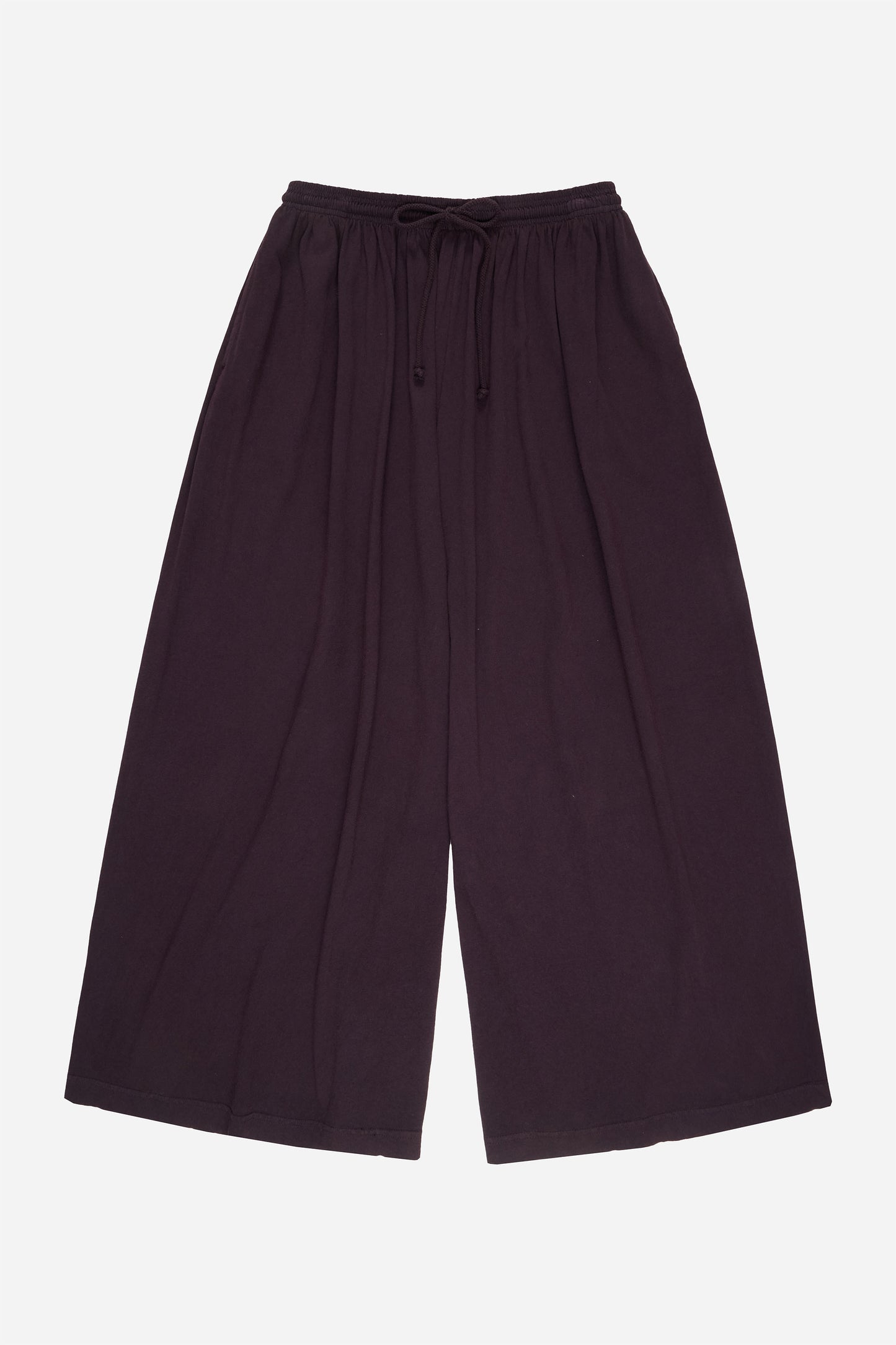 Flat lay: pant legs smoothed out, showing pant leg opening is as wide as the waistband.