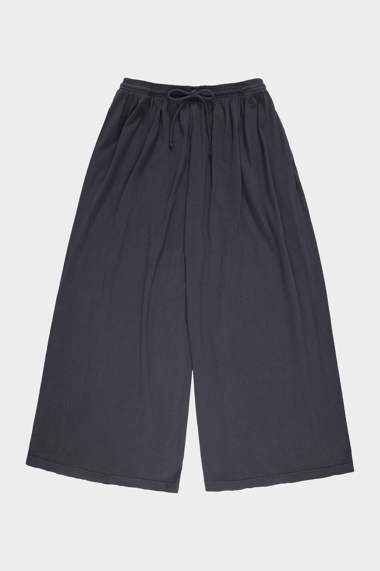 Flat lay of slate colored Tubular Pants on a light gray background