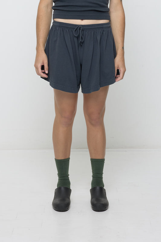Front view: 6' person in Slate Tubular Shorts. Front hem hits upper mid thigh, and gets shorter at the sides.