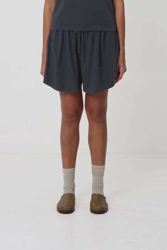 5'10" person in Slate Tubular Shorts. Front hem hits upper mid thigh, and gets shorter at the sides.