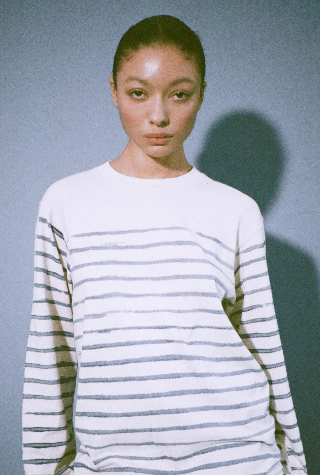 Model in the studio wearing Stripe Straight Sleeve Trash Tee