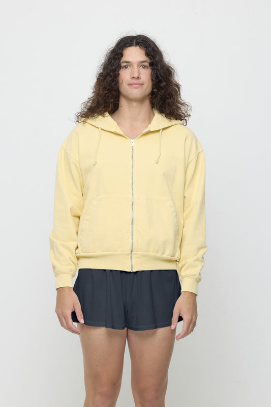 A 6' person wearing French Butter Trash Zip Up Hoodie in size S. Hem hits mid hip.