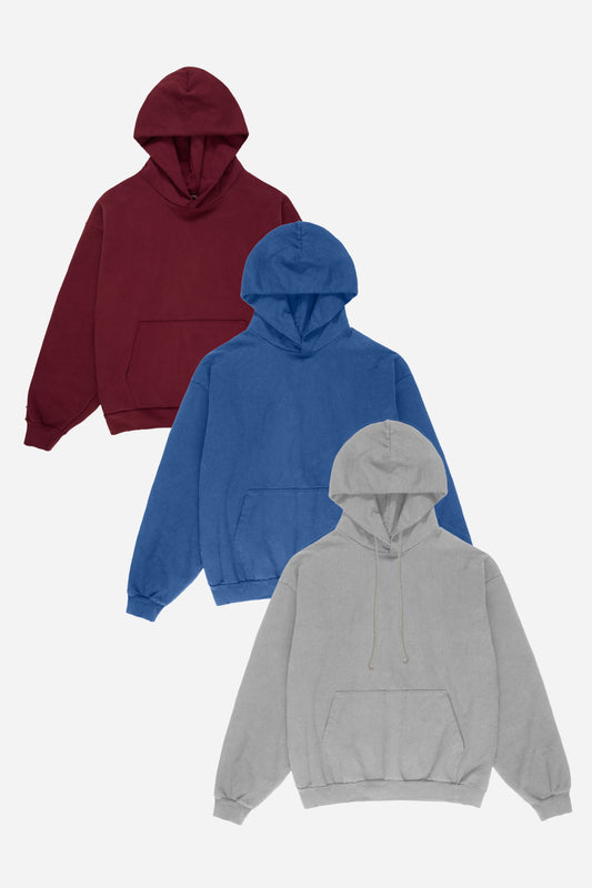 Flat lay of three hoodies in Burgundy, Denim blue, and Grey