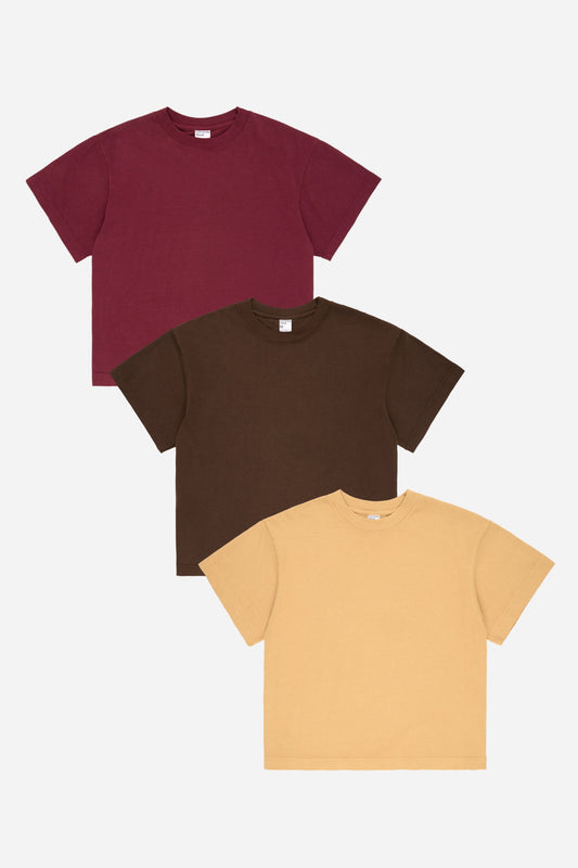 Flat lay of Amber and Soil Boxier Trash Tees