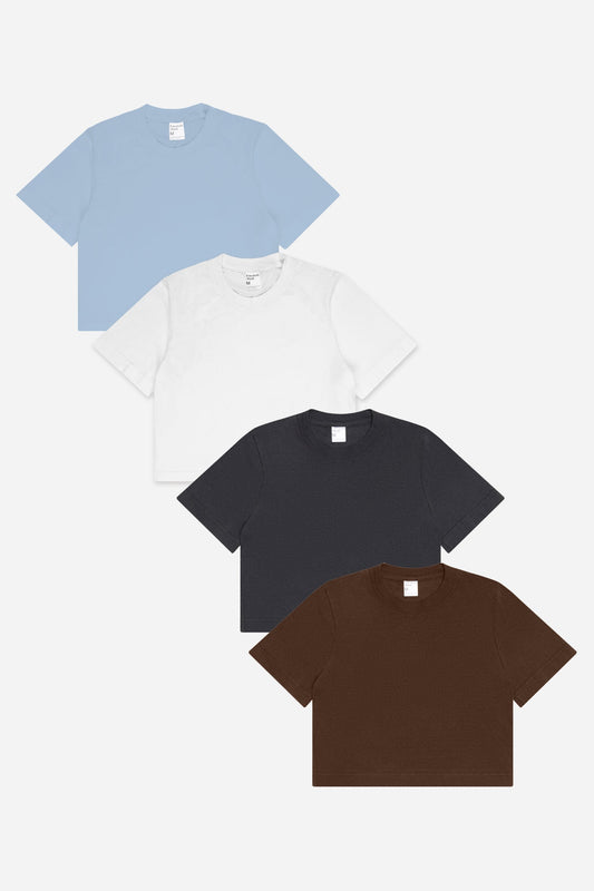 Flat lay of White, Slate and Fog (light blue) baby tees