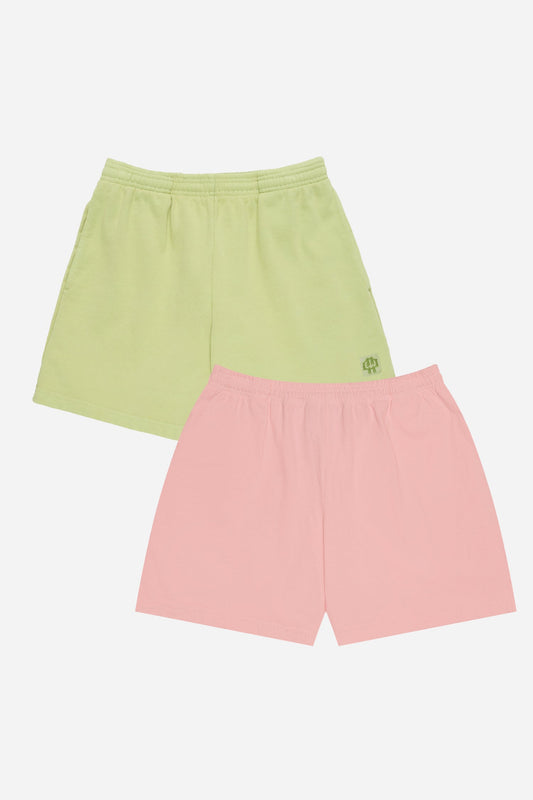 Two pairs of shorts, one green and one pink, on a white background.