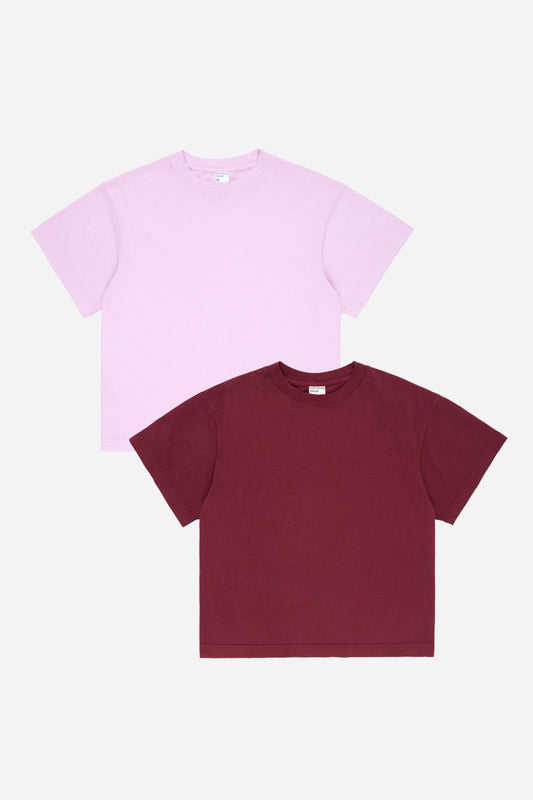 Two t-shirts, one lavender and one burgundy, on a white background