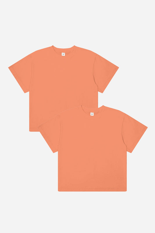 Two dark peach t-shirts on a white background
