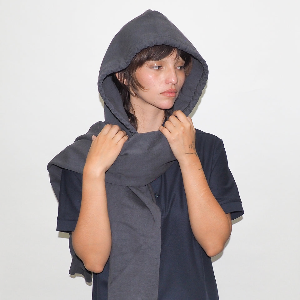 Person wearing a Slate Clyde x Everybody.World Hoodie Scarf against a white background