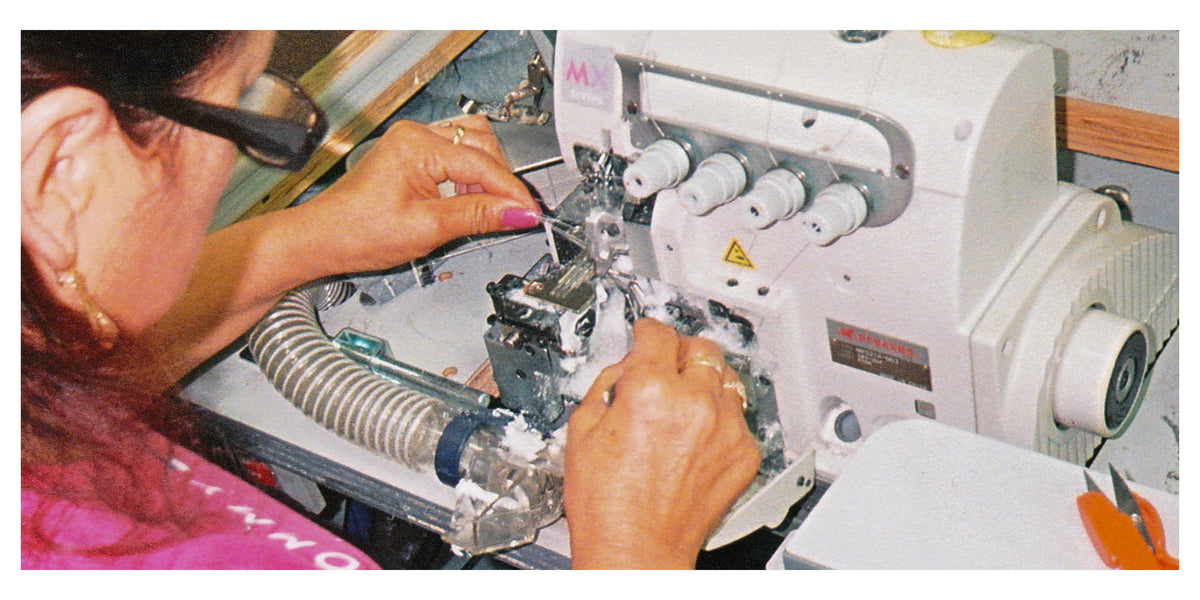 A photo of our valued worker creating Reclaimed Waste Cotton for us.