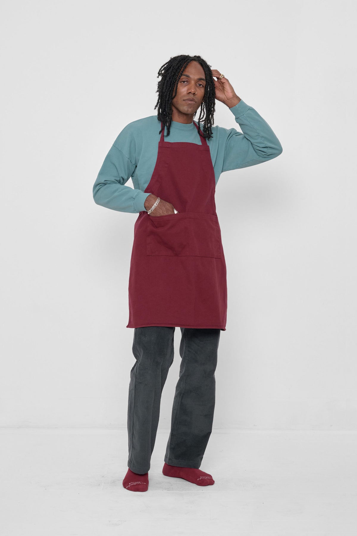 Adjustable Apron in Garnet – styled with Slate Cord Pants, Garnet Squishy Socks and Oyster top