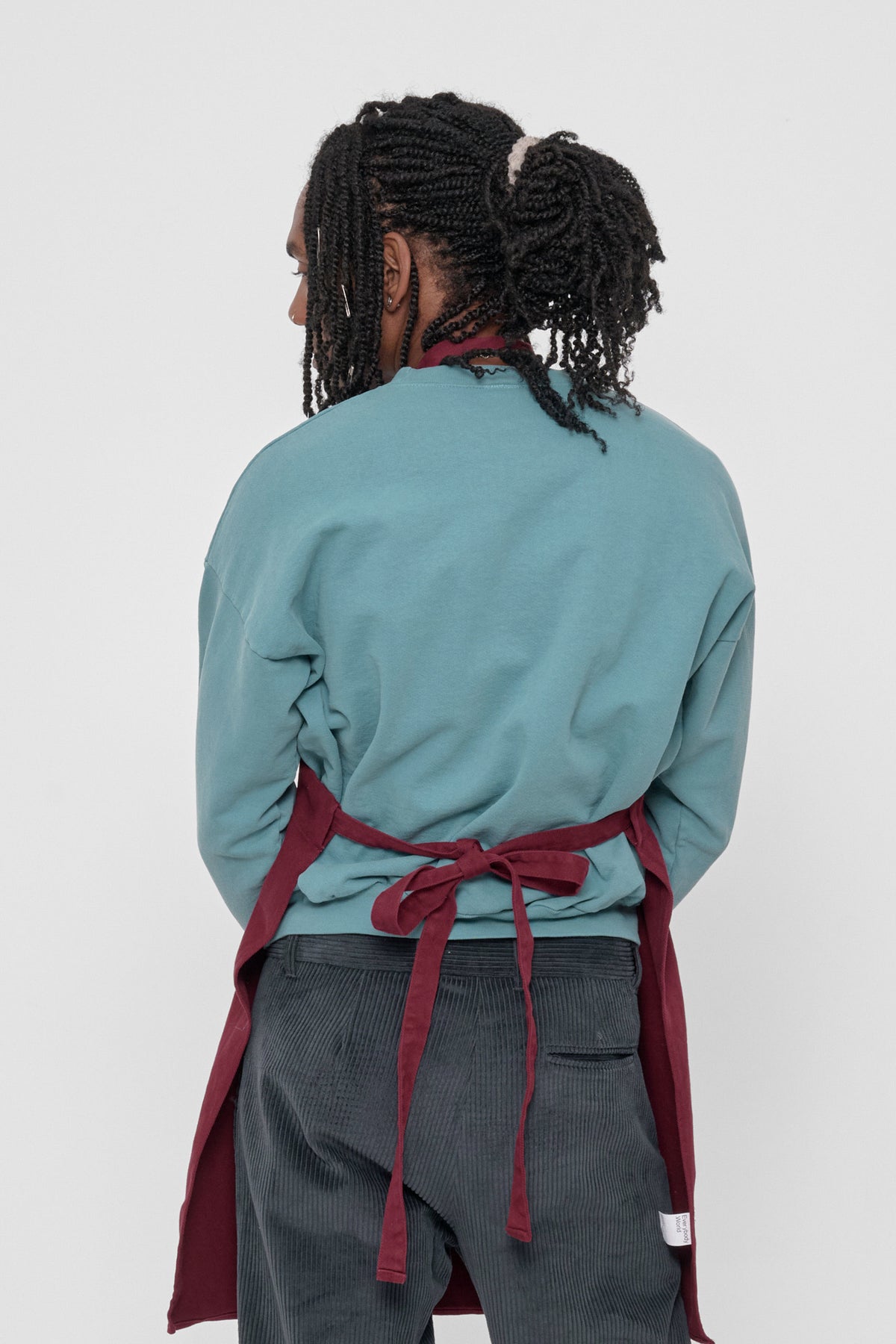 Adjustable Apron in Garnet – back view on model, waist strap tied